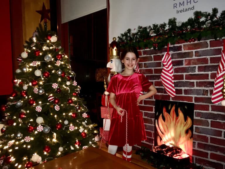 Little girl beside Christmas tree at RMHC house
