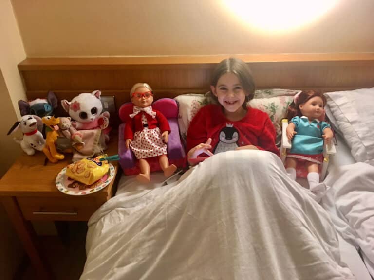 Little girl with girl dolls
